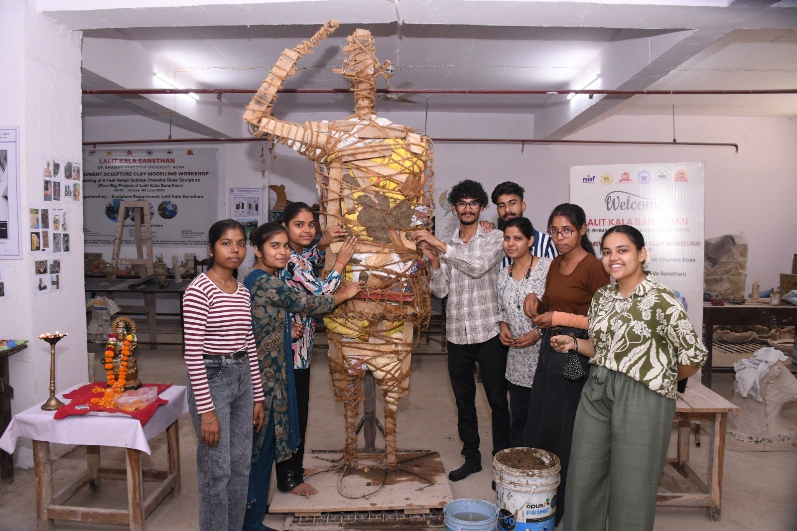 Students and faculty members participating in the Monumental Sculpture Clay Modeling Workshop at Dr Bhimrao Ambedkar University Agra, creating an 8-foot statue of Netaji Subhas Chandra Bose.