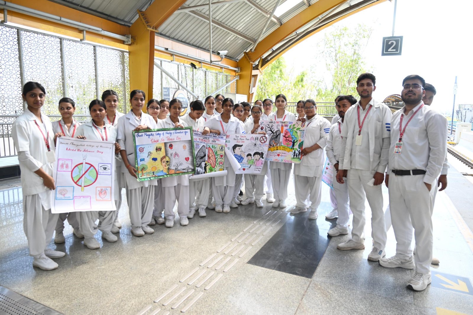 Students and Agra Metro staff conducting World Tobacco Day awareness program at Taj Mahal Metro Station with posters and street play to promote tobacco-free life