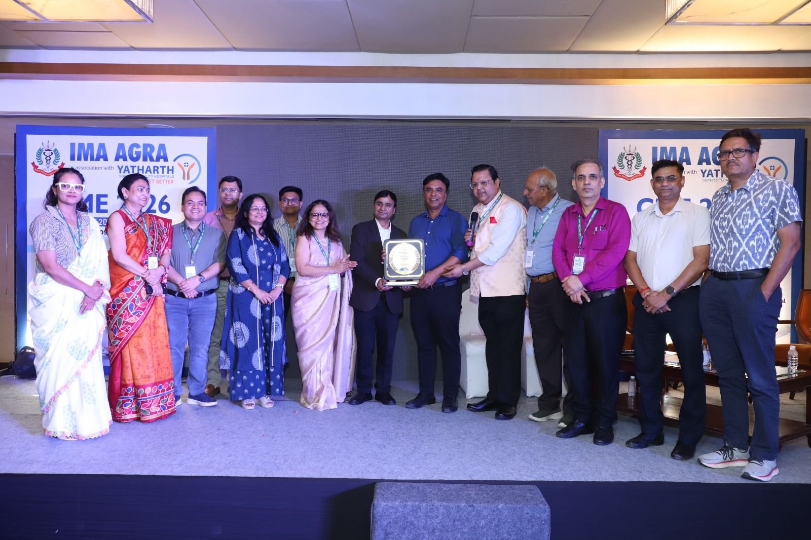 Doctors on stage during a scientific discussion at IMA Agra CME 2026 held at Holiday Inn Agra, focusing on AI, robotic surgery and future healthcare innovations.