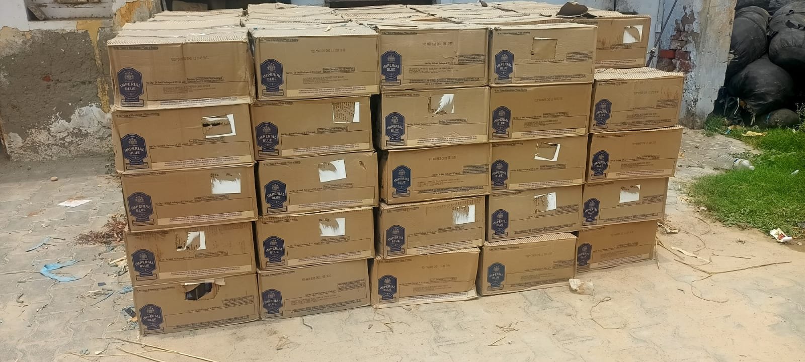 Cartons of illegal English liquor worth Rs 60 lakh seized by Agra Police during a major interstate smuggling crackdown.